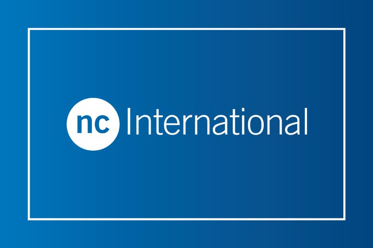 NC International logo in white coloured font on a blue background